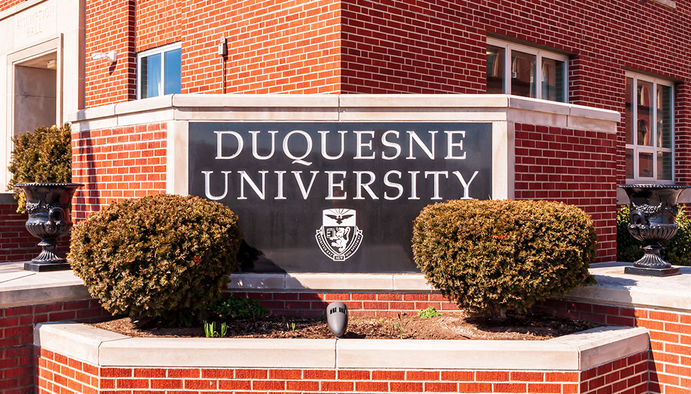 Duquesne University sign on a brick building