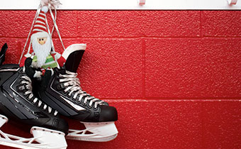 Hockey skate hanging against a red wall